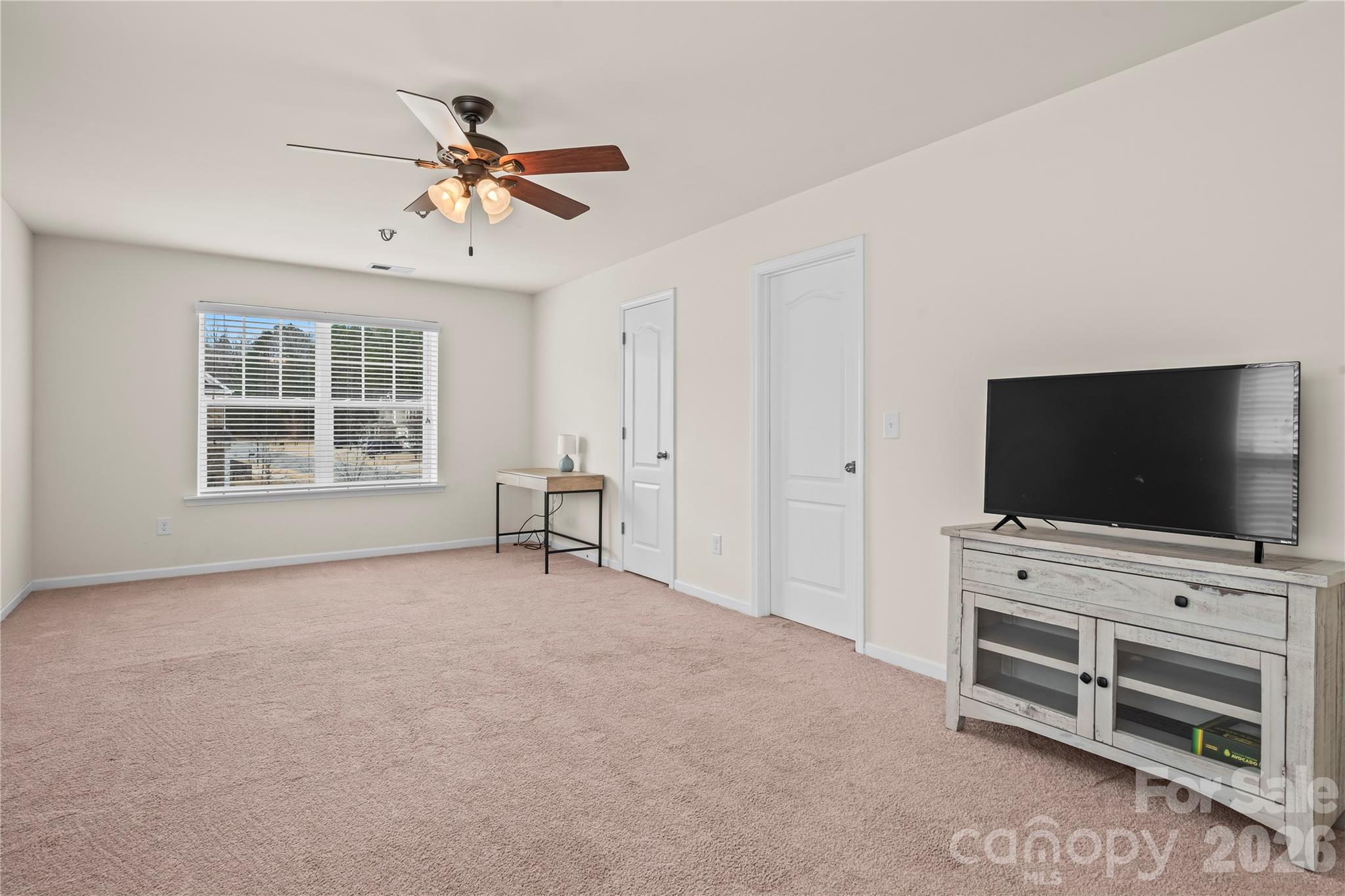 10666 Sapphire Trail Davidson, NC 28036 - Photo 23 of 34 a view of a livingroom with furniture and a flat screen tv