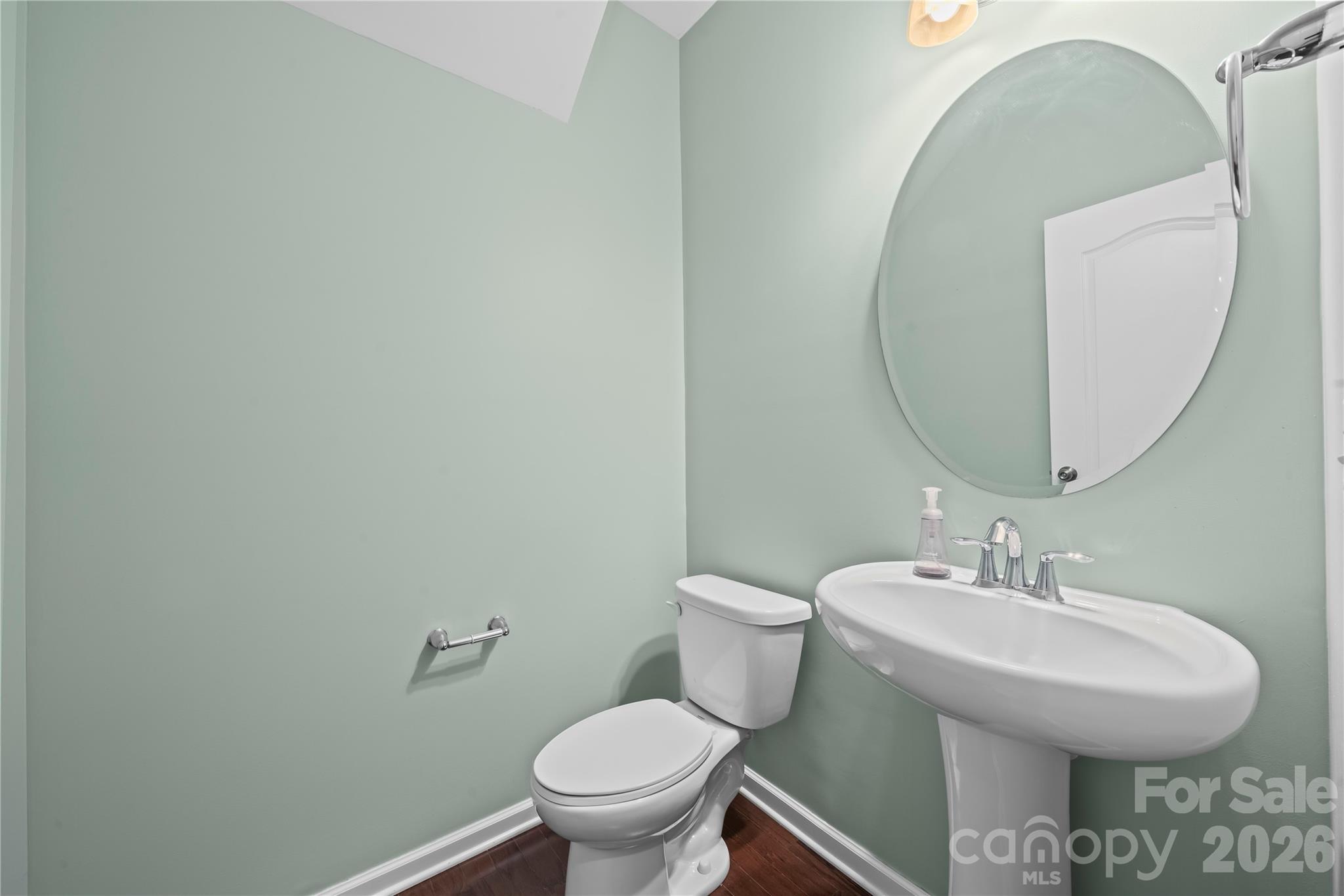 10666 Sapphire Trail Davidson, NC 28036 - Photo 7 of 34 a bathroom with a toilet sink and mirror