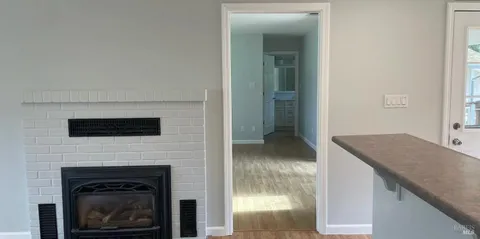 a living room with a fireplace and a flat screen tv