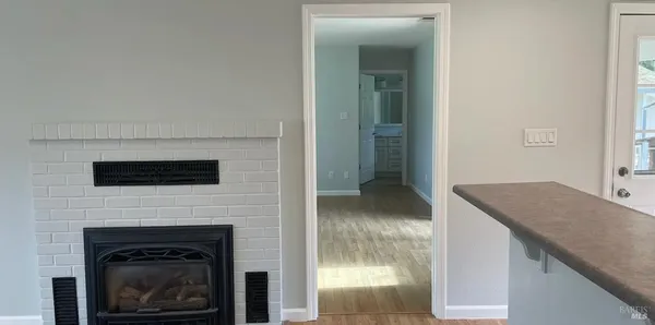 a living room with a fireplace and a flat screen tv