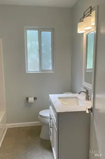 a bathroom with a sink toilet and mirror
