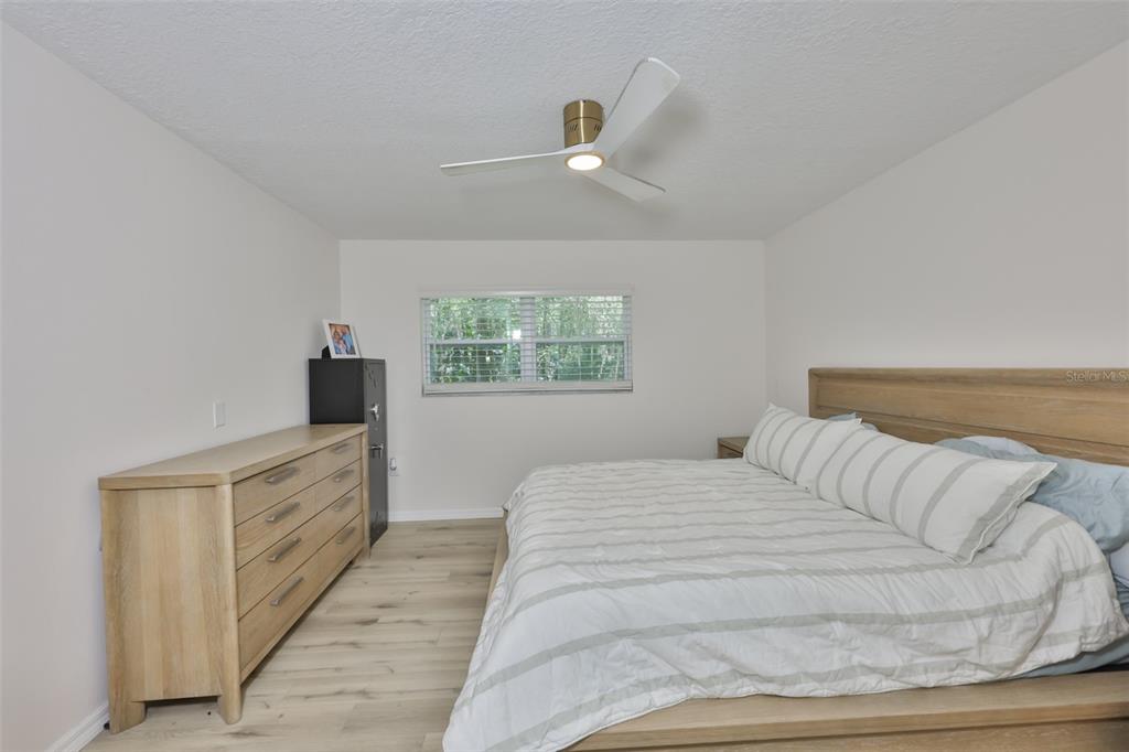 1578 Indian Bay Road Spring Hill, FL 34607 - Photo 27 of 51 a spacious bedroom with a bed and a window