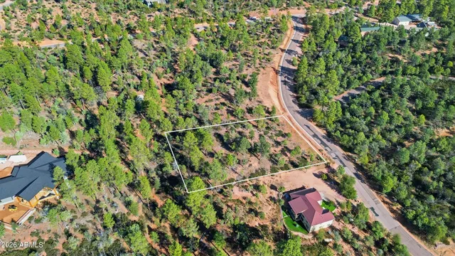 a view of a lush green hillside and a houses