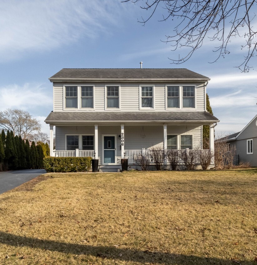 a front view of a building with a garden