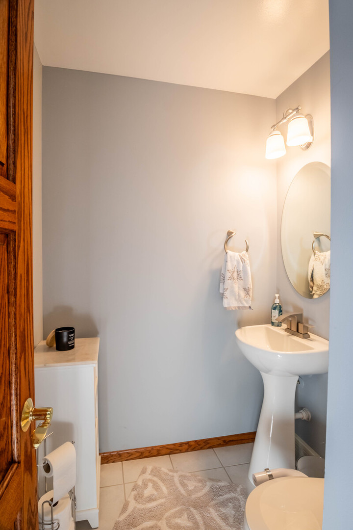 2306 Jay Lane Rolling Meadows, IL 60008 - Photo 12 of 30 a bathroom with a sink mirror and toilet