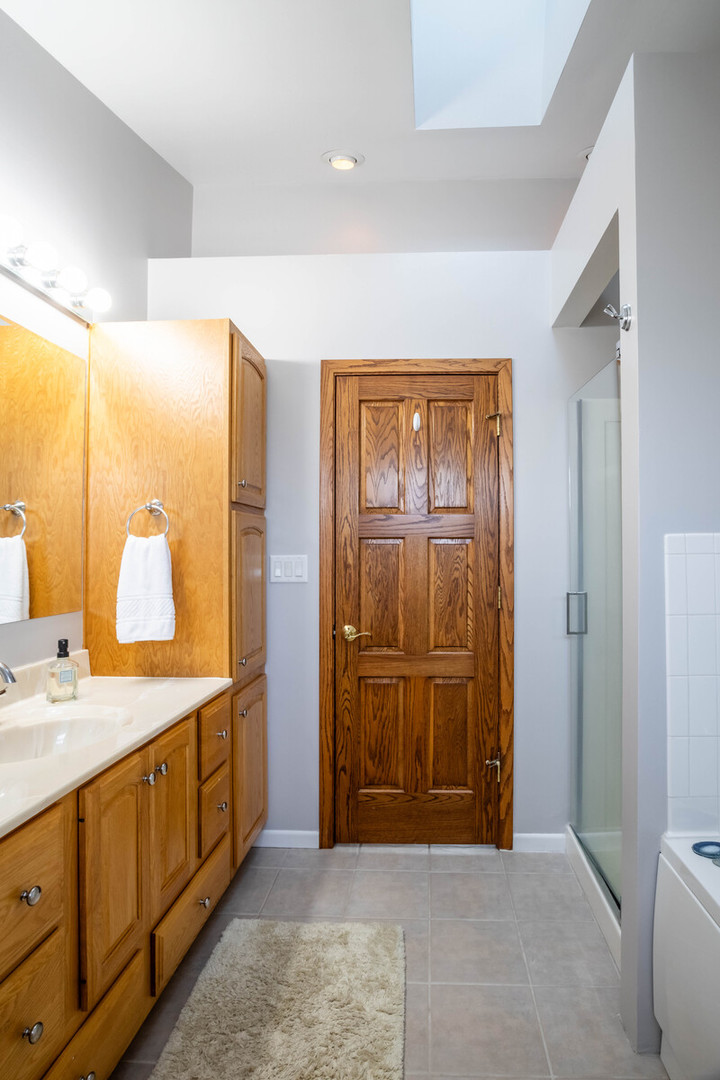 2306 Jay Lane Rolling Meadows, IL 60008 - Photo 17 of 30 a bathroom with a double vanity sink and a mirror