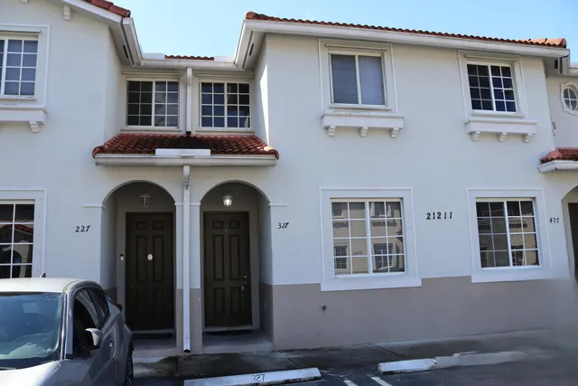 a front view of a house with large windows