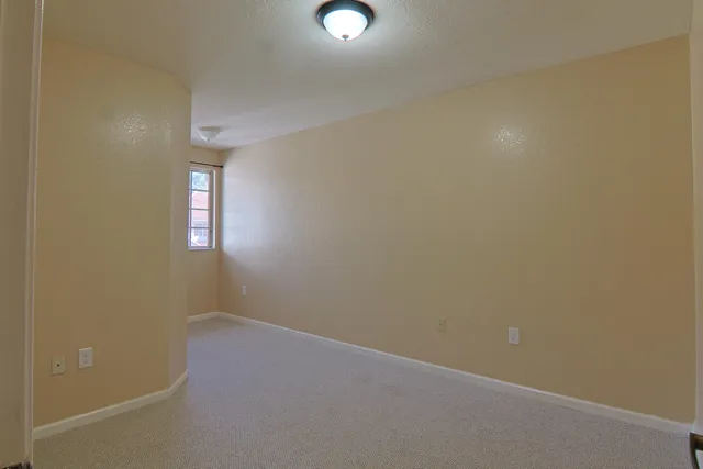 an empty room with windows and entrance