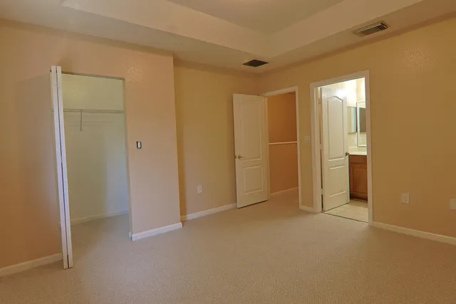 a view of an empty room and closet area