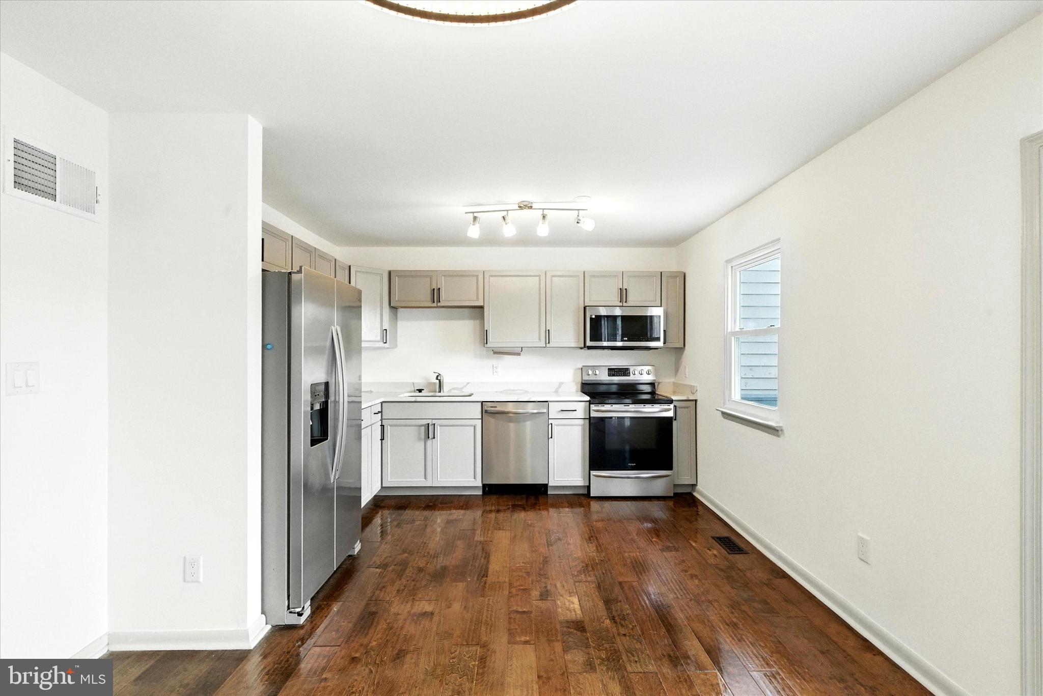 754 Custis Street Aberdeen, MD 21001 - Photo 4 of 19 a kitchen with a refrigerator and a stove top oven