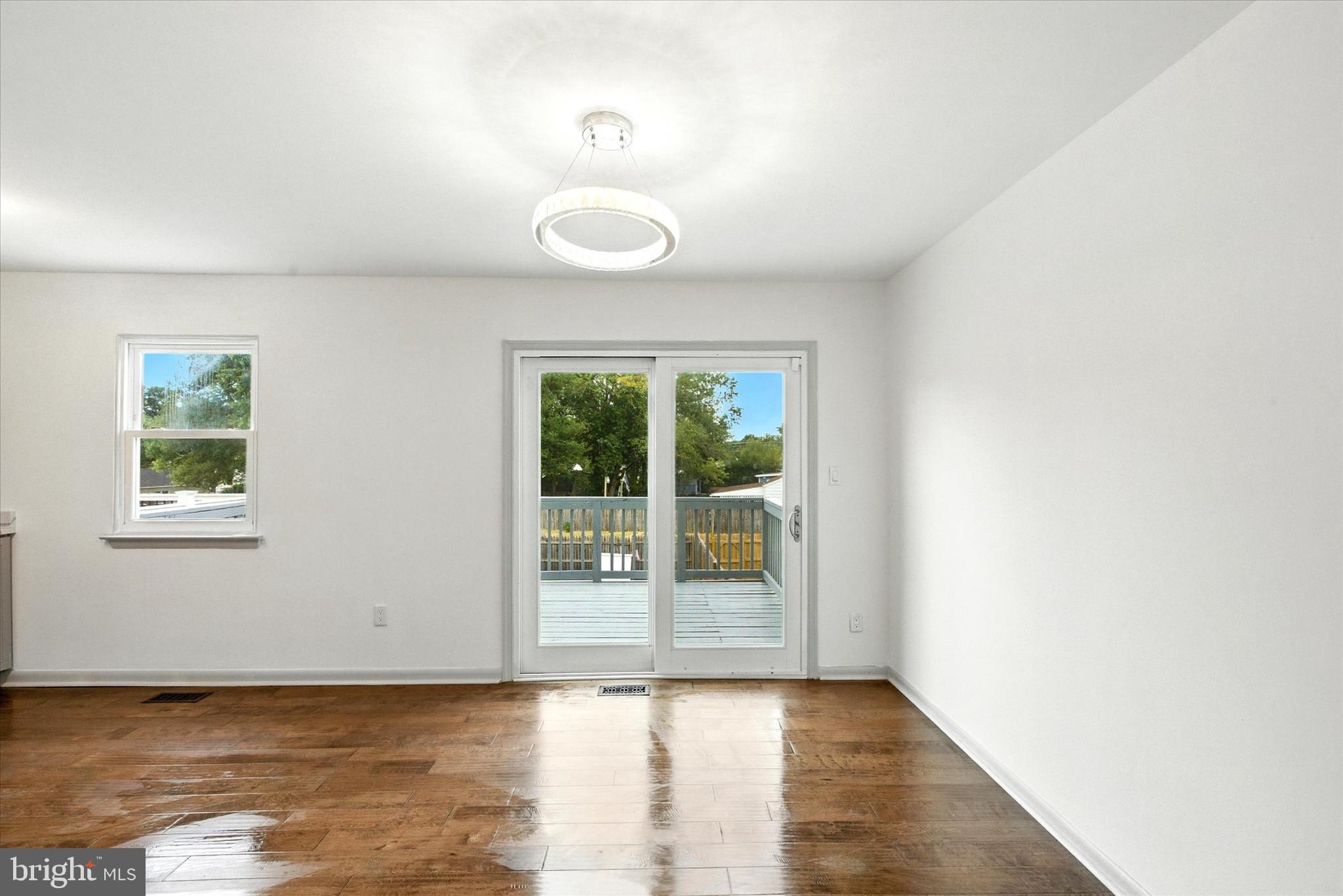 754 Custis Street Aberdeen, MD 21001 - Photo 6 of 19 an empty room with wooden floor and windows