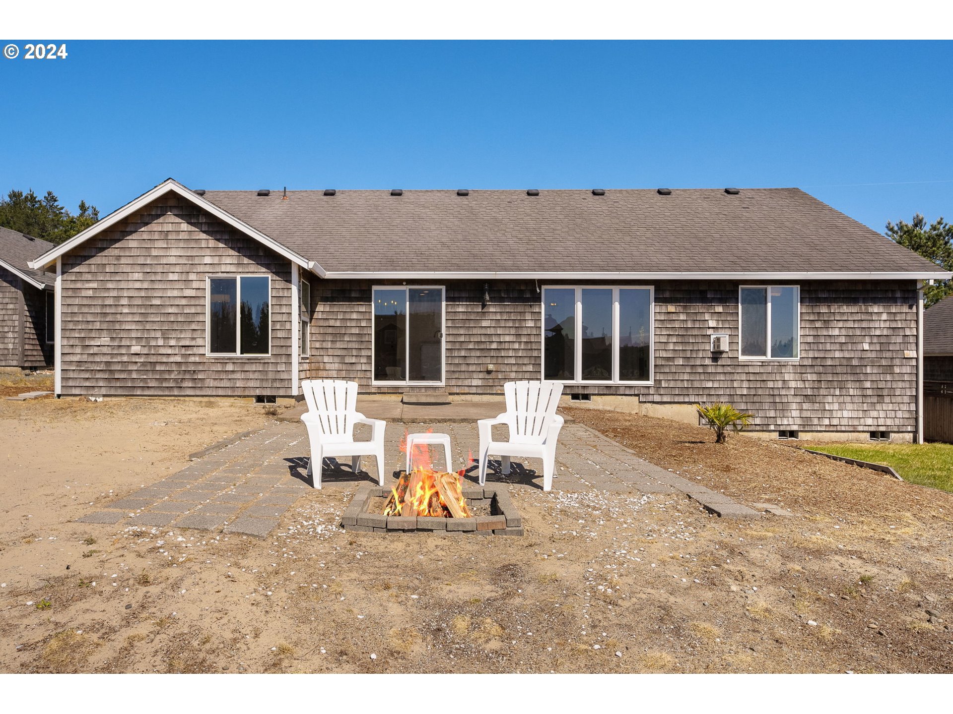9980 Pine Ridge Drive Nehalem, OR 97131 - Photo 24 of 27 a backyard of a house with table and chairs