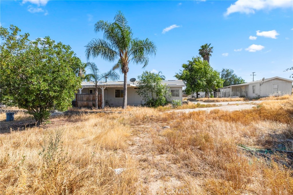 18420 Decker Road Perris, CA 92570 - Photo 10 of 15 a backyard of a house with table and chairs under an umbrella