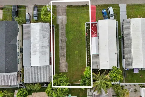 an aerial view of a house with balcony and garden