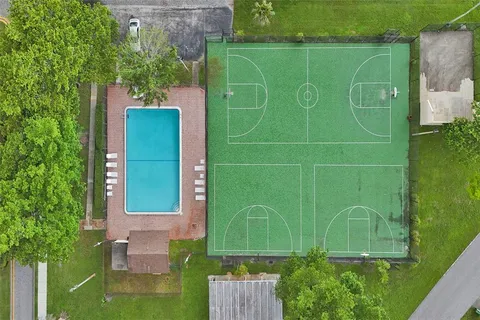 a green field with some trees in the background