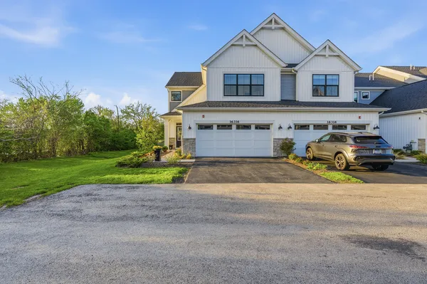 a front view of a house with a yard and garage