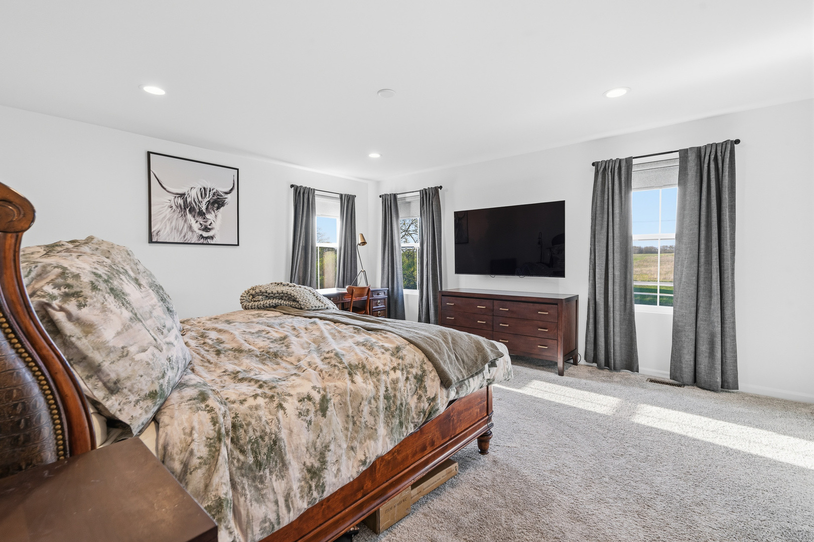 16316 Wheatgrass Street Lockport, IL 60441 - Photo 16 of 37 a spacious bedroom with a bed and a flat screen tv