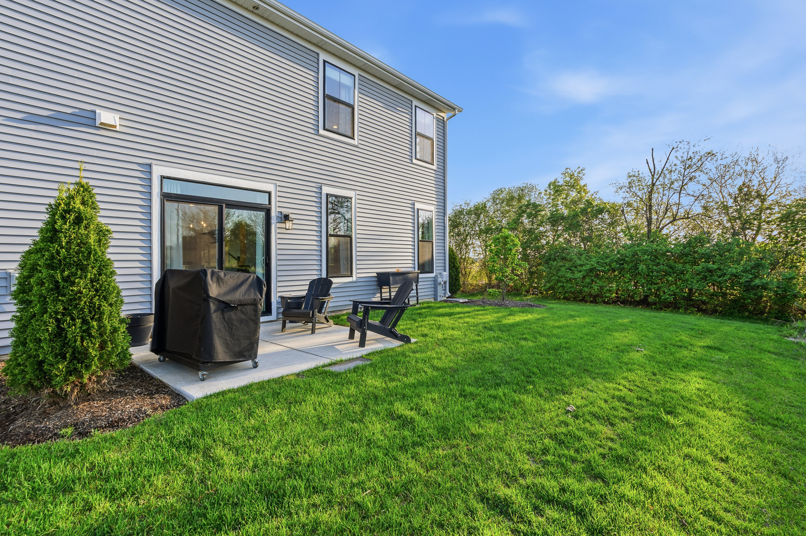 16316 Wheatgrass Street Lockport, IL 60441 - Photo 24 of 37 a view of a backyard with chairs potted plants and a wooden fence