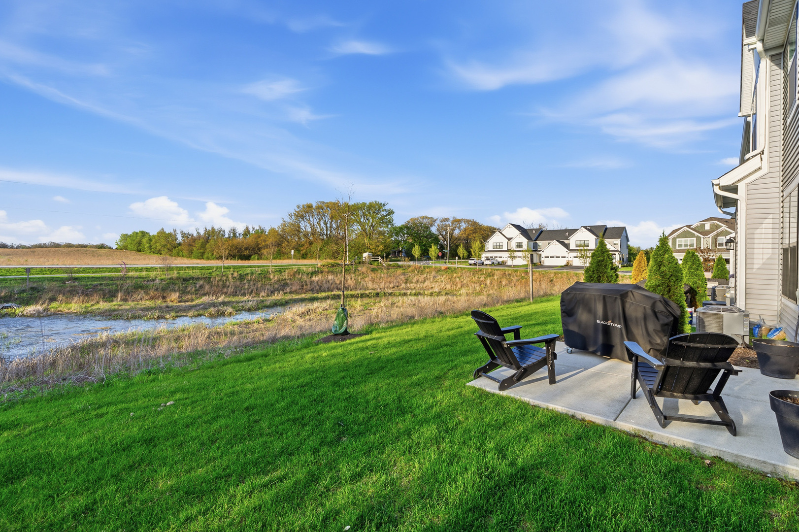 16316 Wheatgrass Street Lockport, IL 60441 - Photo 26 of 37 a view of a lake with table and chairs