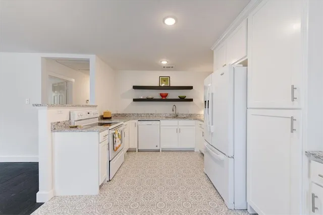 a kitchen with a sink a refrigerator and a stove