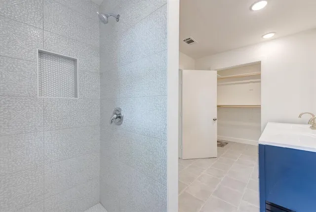 an empty room with wooden floor and window