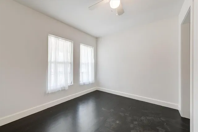 a bathroom with a granite countertop sink a toilet and a mirror