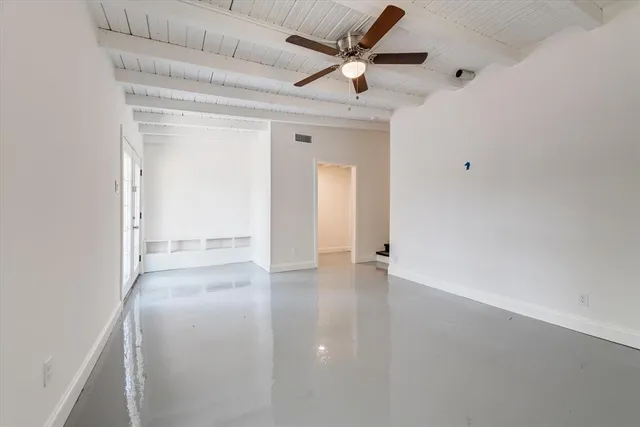 a backyard of a house with barbeque oven table and chairs