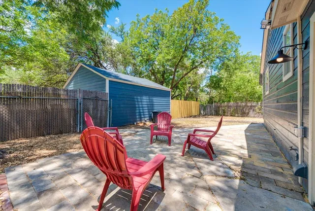 a backyard of a house with table and chairs