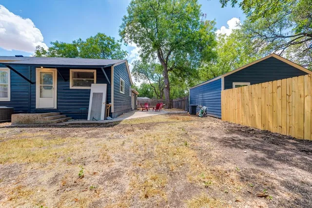 a view of backyard with table and chairs and a barbeque
