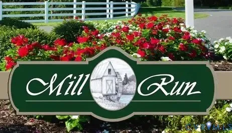 a sign that is sitting in front of flowers