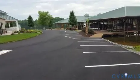 a front view of a house with a yard and tree
