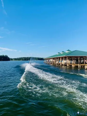 an aerial view of a house with a garden and lake view