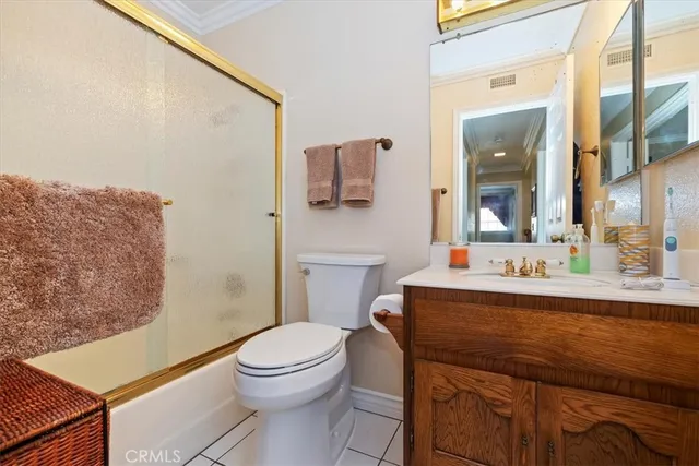 a bathroom with a sink a toilet a mirror and shower