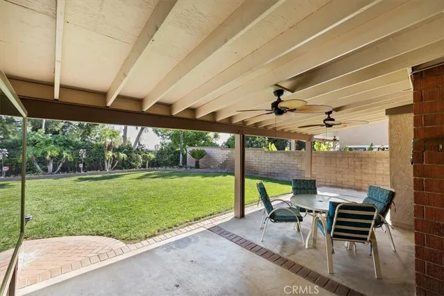 a patio with yard glass top table and chairs