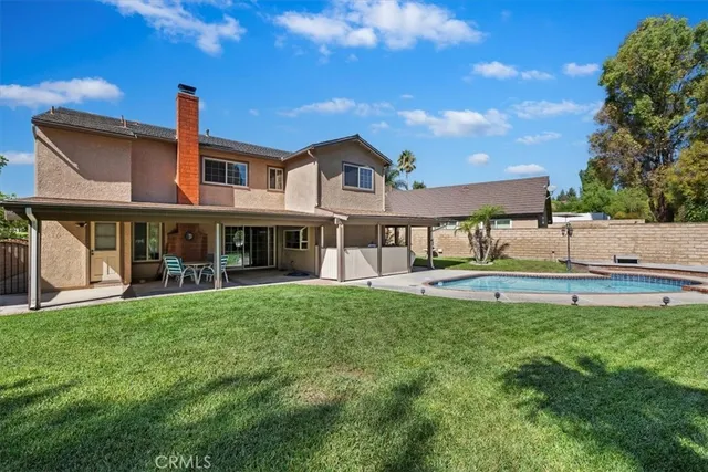 a view of a house with a yard and sitting area
