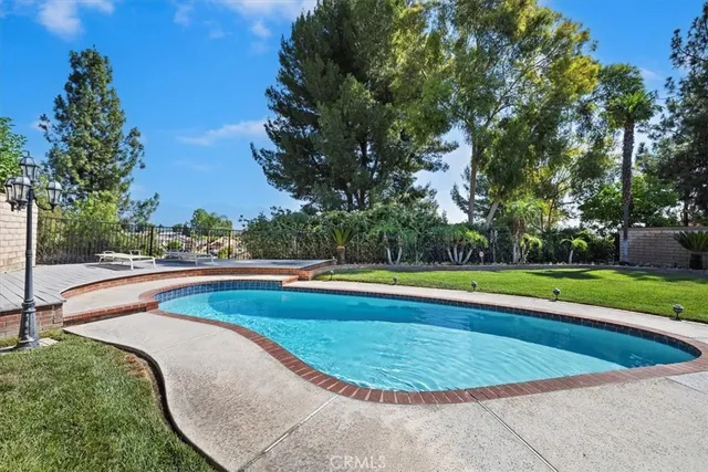 a view of a swimming pool and a yard