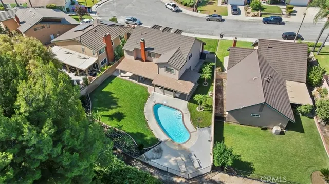 an aerial view of a house with a swimming pool