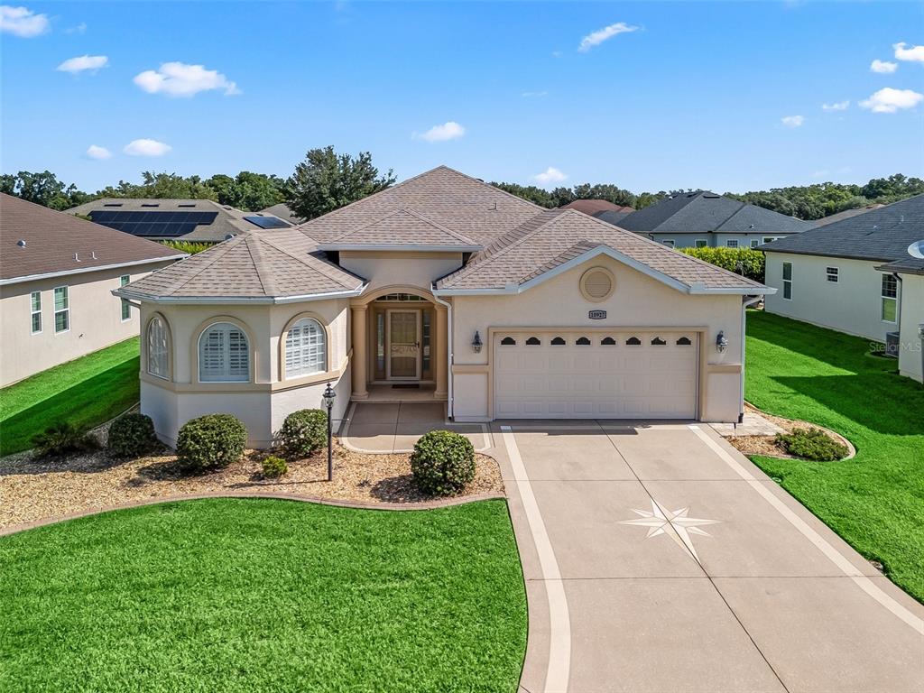 10927 Southeast 168TH Loop Summerfield, FL 34491 - Photo 1 of 1 a front view of a house with a yard and garage