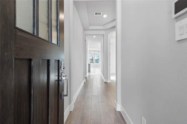 a view of a hallway with wooden floor