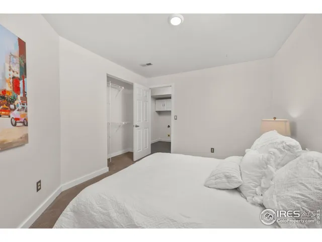 a bedroom with a bed and a painting