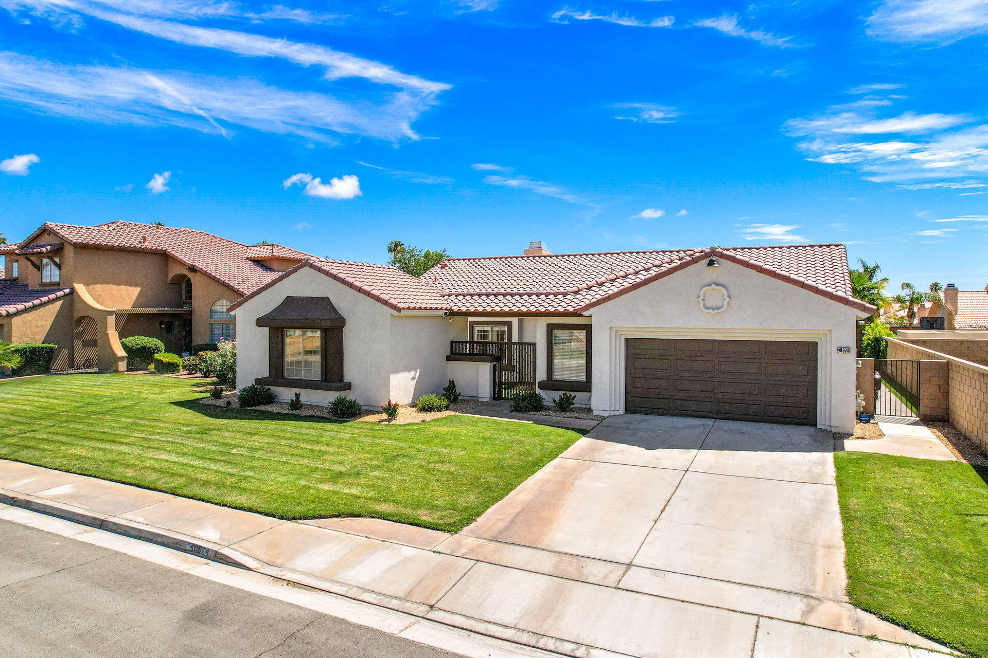 48674 Gibraltar Street Indio, CA 92201 - Photo 11 of 49 a front view of a house with a garden and yard