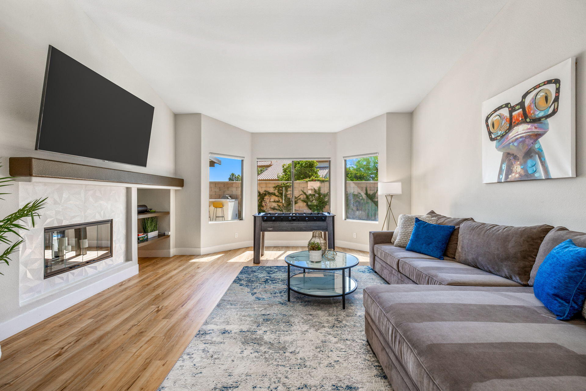 48674 Gibraltar Street Indio, CA 92201 - Photo 16 of 49 a living room with furniture a flat screen tv and a fireplace