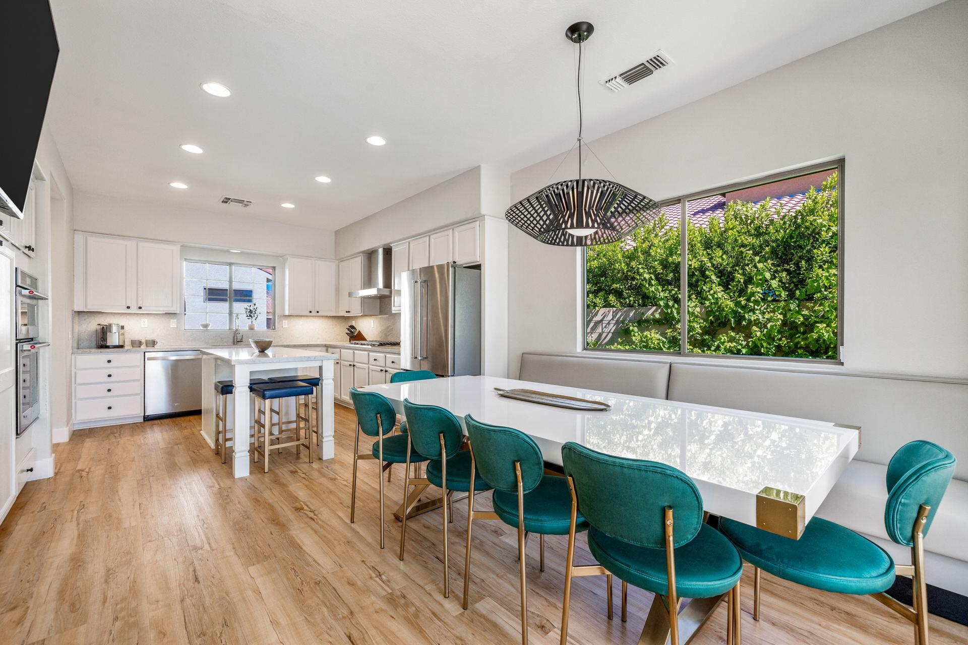 48674 Gibraltar Street Indio, CA 92201 - Photo 19 of 49 a view of a dining room and livingroom with furniture wooden floor a chandelier