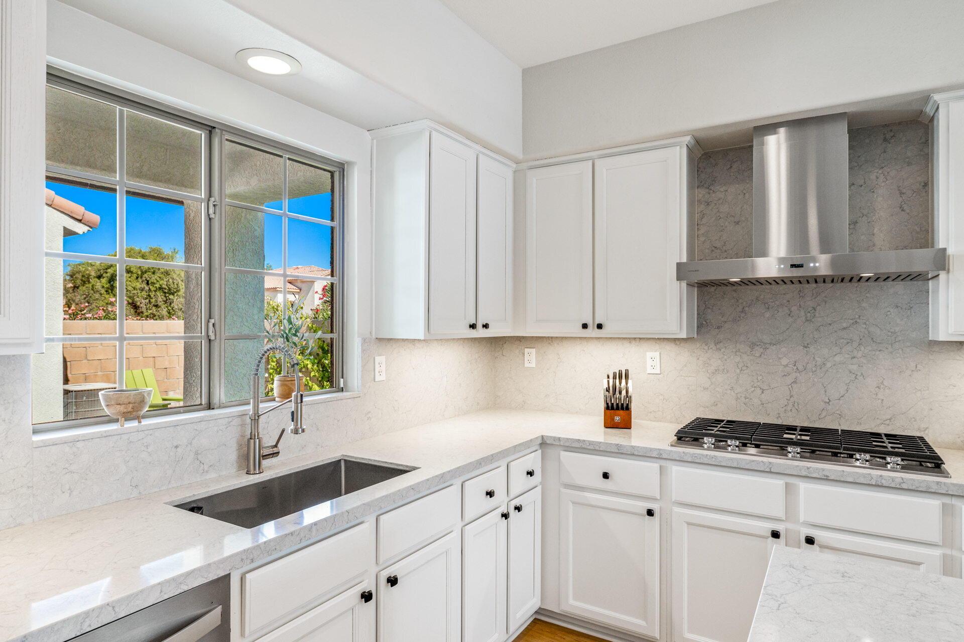 48674 Gibraltar Street Indio, CA 92201 - Photo 24 of 49 a kitchen with granite countertop a sink a stove and cabinets