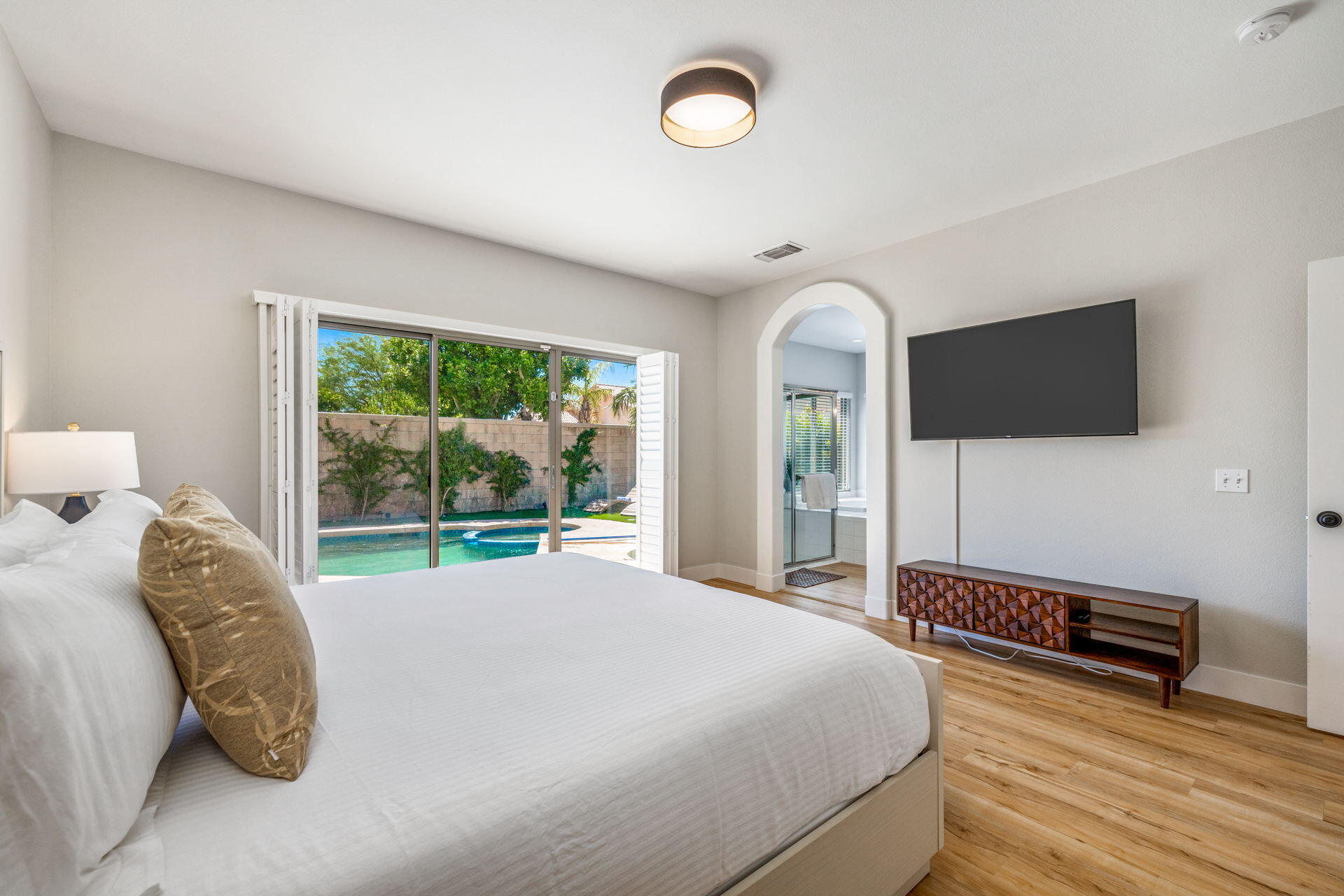48674 Gibraltar Street Indio, CA 92201 - Photo 27 of 49 a bedroom with a bed and a flat tv screen on dresser