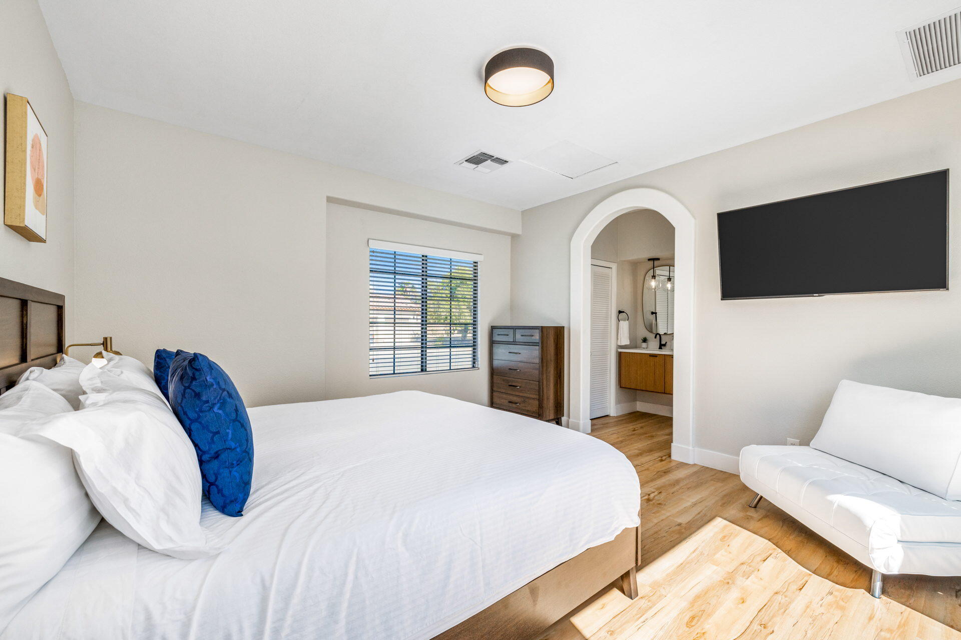 48674 Gibraltar Street Indio, CA 92201 - Photo 34 of 49 a spacious bedroom with a bed and a flat screen tv