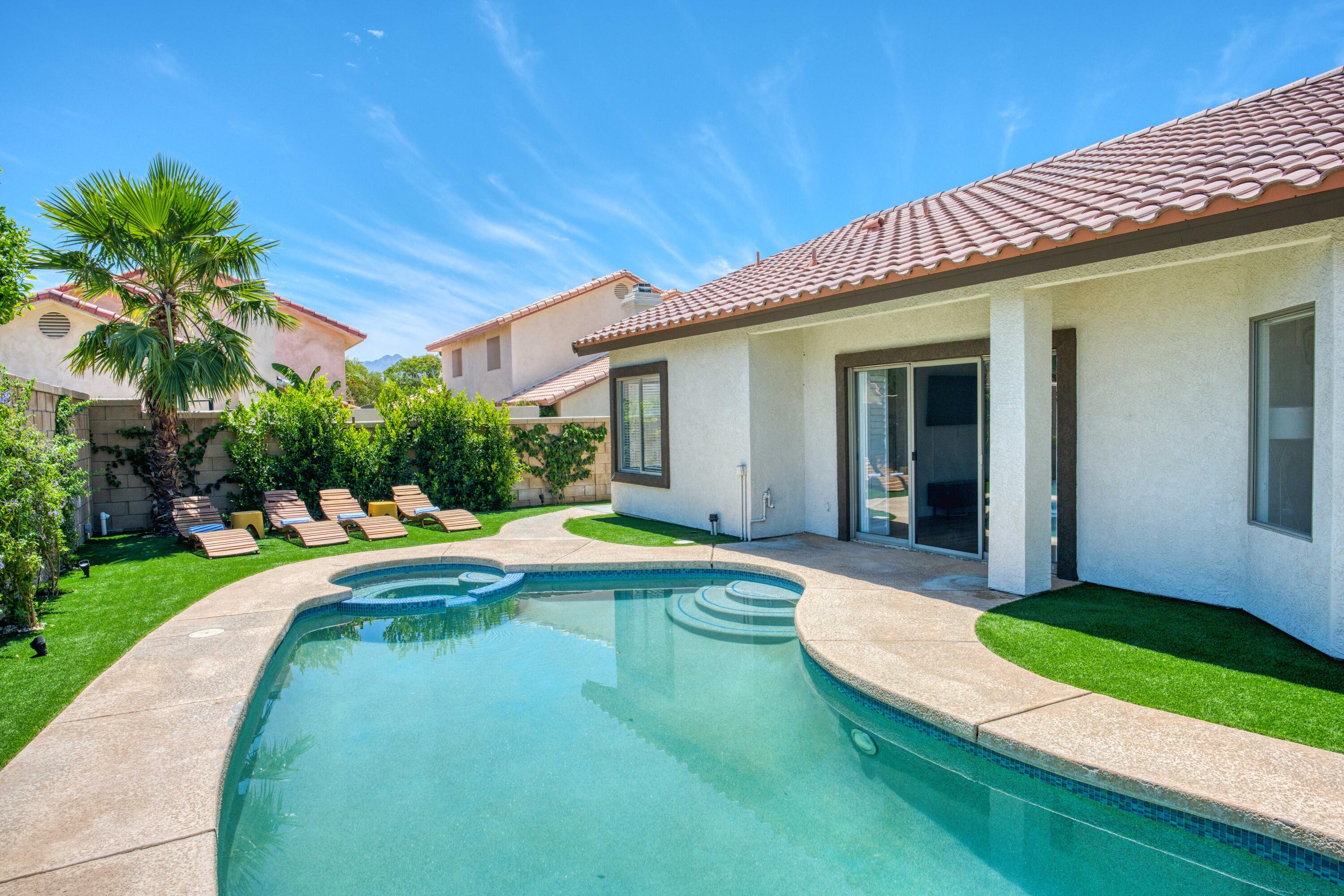 48674 Gibraltar Street Indio, CA 92201 - Photo 44 of 49 a view of a house with swimming pool and a yard