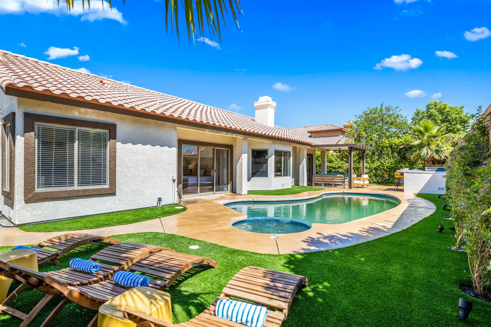 48674 Gibraltar Street Indio, CA 92201 - Photo 48 of 49 a front view of house with yard swimming pool and outdoor seating