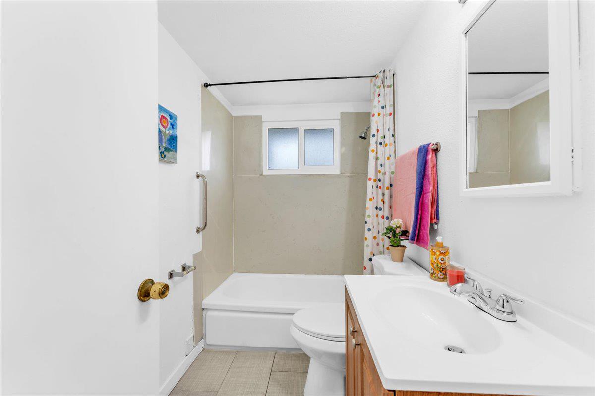 27837 Ormond Avenue Hayward, CA 94544 - Photo 17 of 26 a bathroom with a sink vanity mirror and toilet