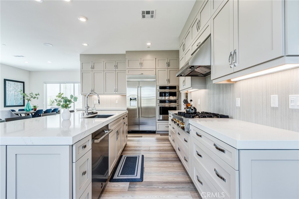 260 Holliston Lake Forest, CA 92630 - Photo 16 of 63 a kitchen with stainless steel appliances a sink stove and cabinets